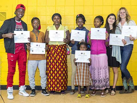 Students work with refugee participants