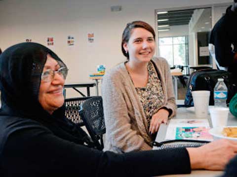 Students work with refugee participants