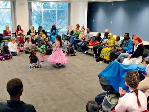 Students work with refugee participants