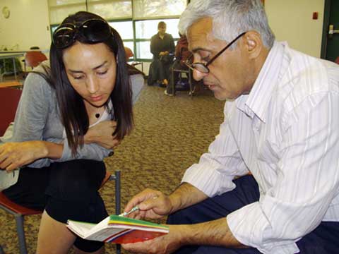 Students work with refugee participants